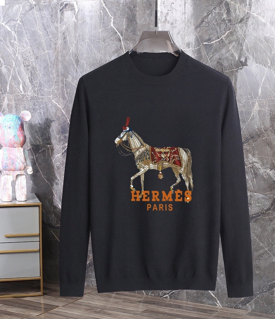 Black sweater with graphic and horse design on a marble background